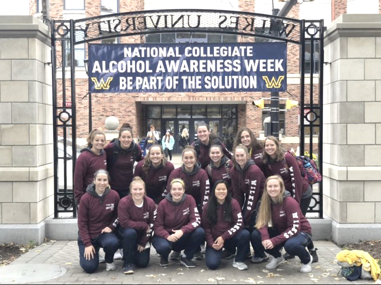 The women’s basketball team poses for a photo together before participating in the awareness walk.
